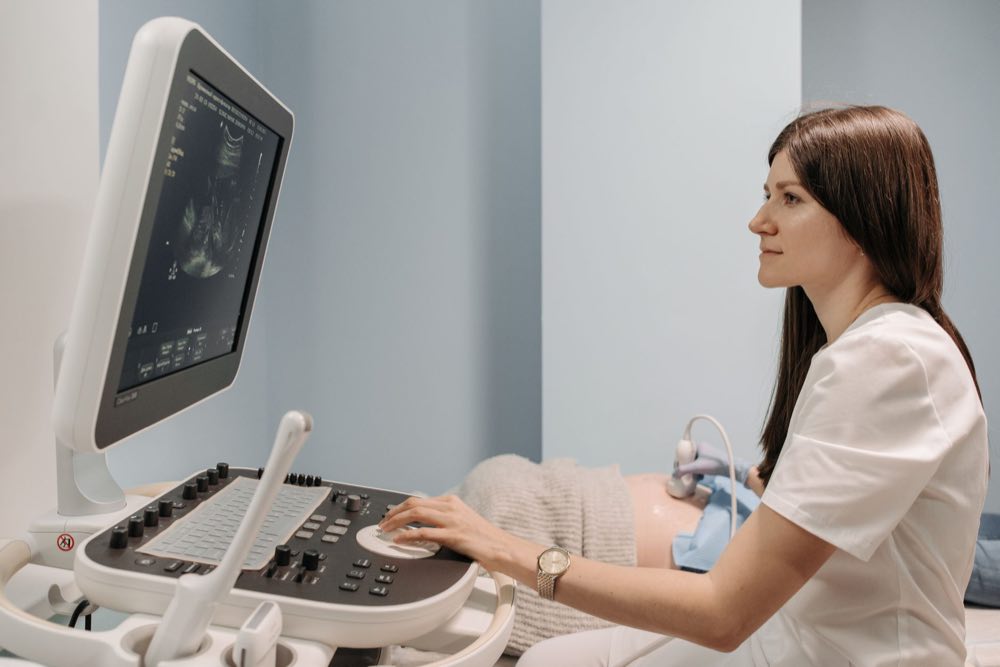 Clinician supporting a woman during a health consultation