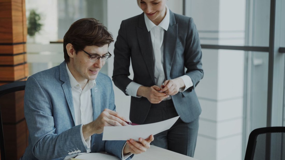 Two senior consultants reviewing a regulatory deliverable together