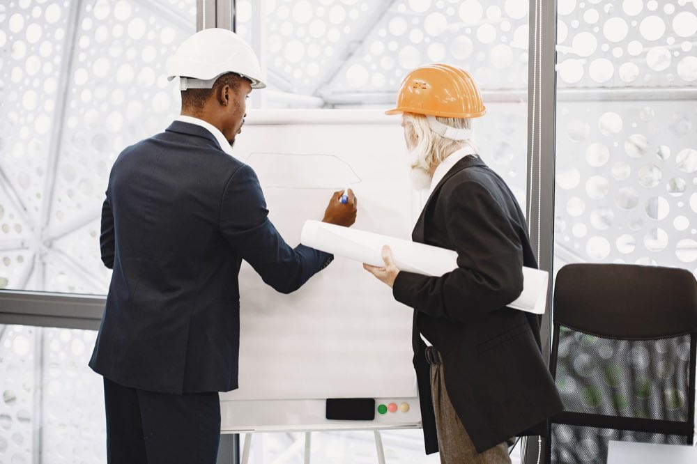 Two software architects discussing a design at a whiteboard