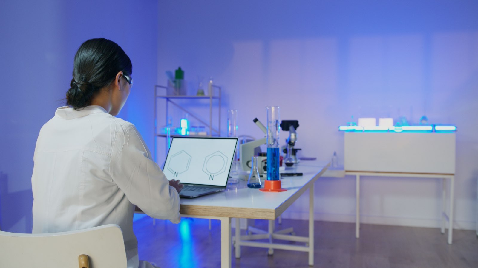 Immunology researcher studying antibody structures in a modern biologics laboratory