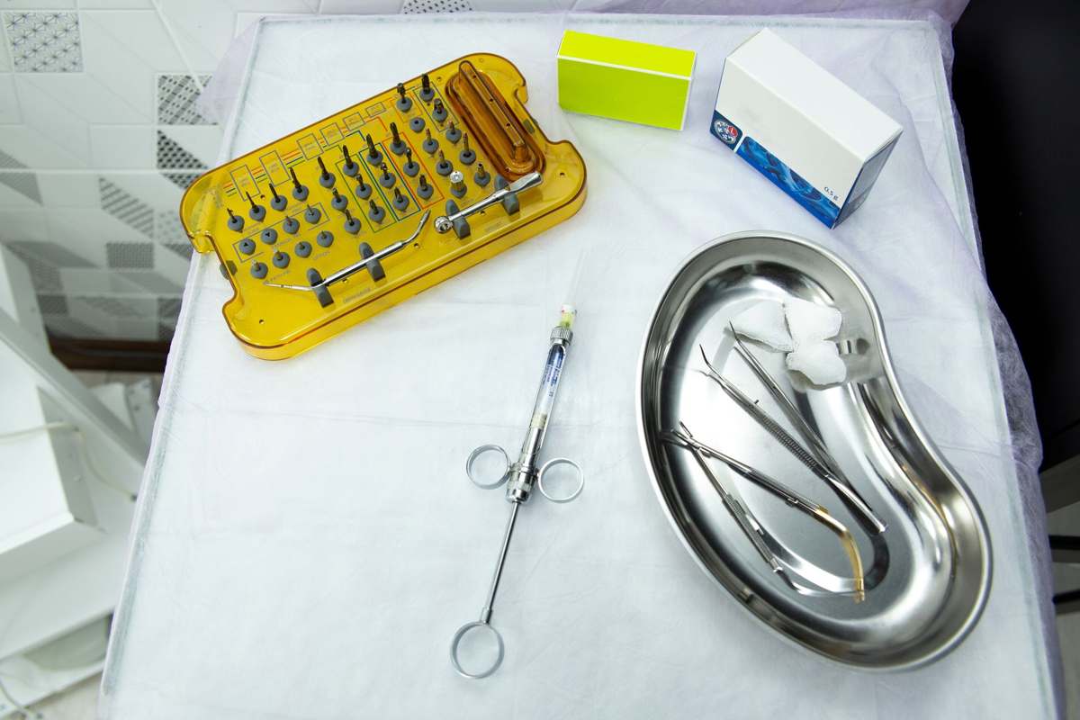 A set of surgical implant instruments and components on a sterile tray