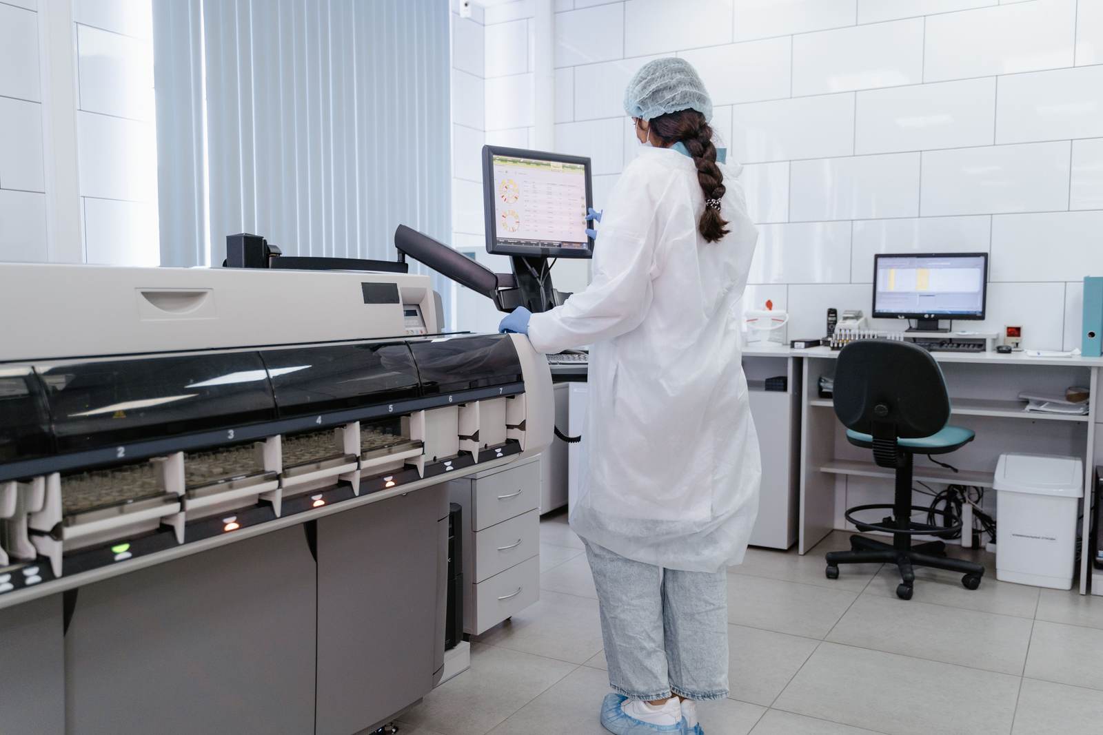 A lab technician working with high-tech equipment in a medical lab