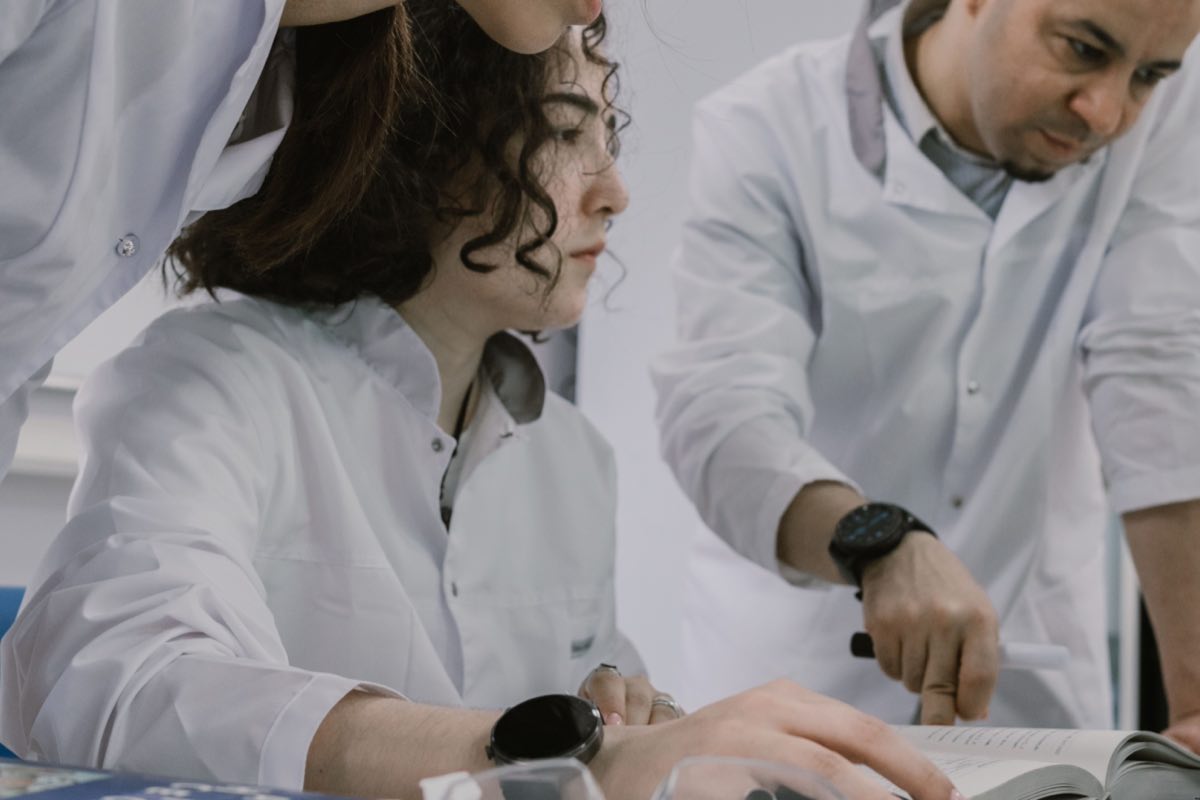 A research team collaborating at the bench in a working laboratory