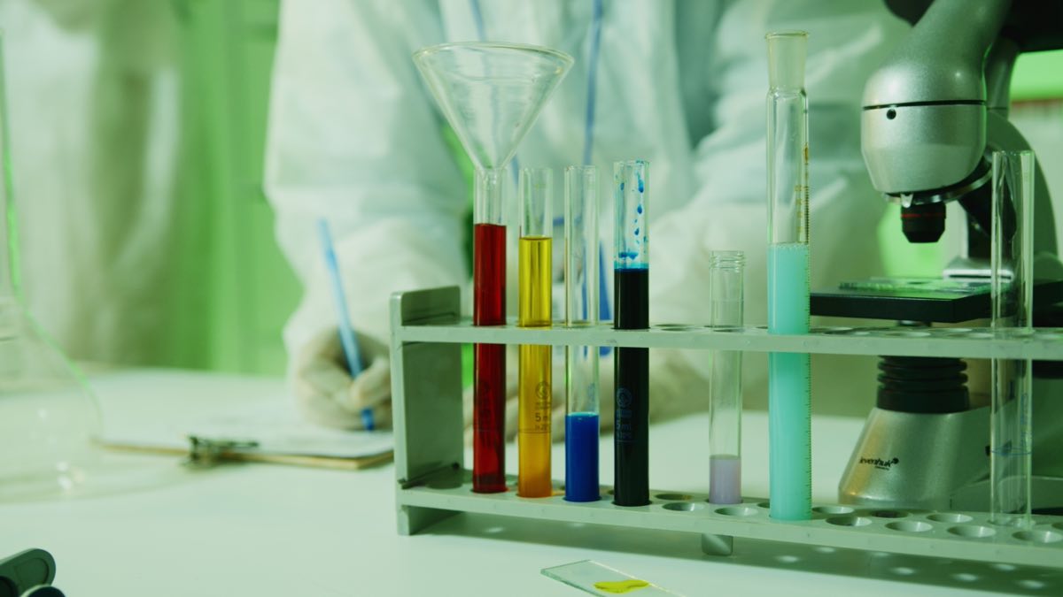 A laboratory research setup with test tubes and a microscope