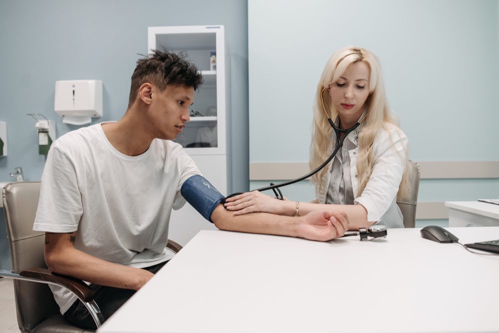 A doctor measuring a patient's blood pressure in a clinic