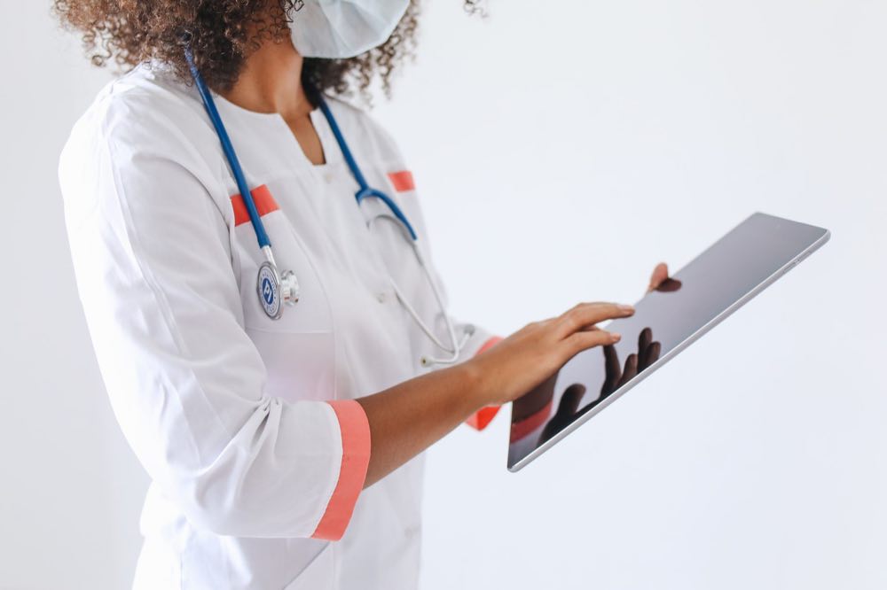 Clinician reviewing health data on a tablet