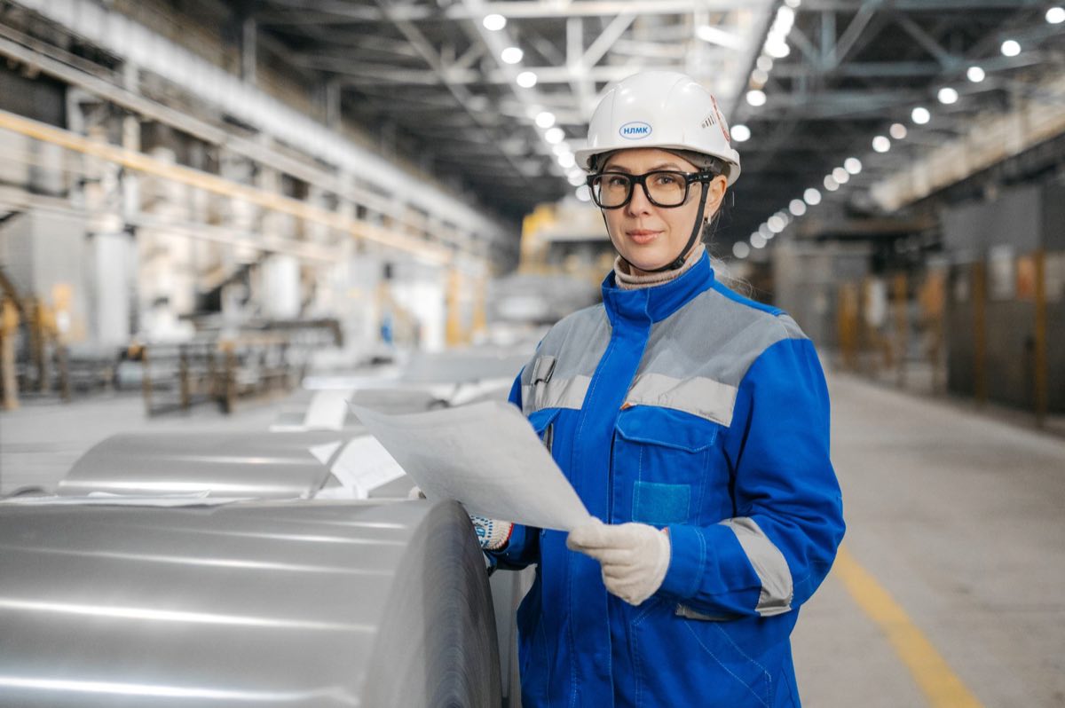 An engineer inspecting machinery in a production facility