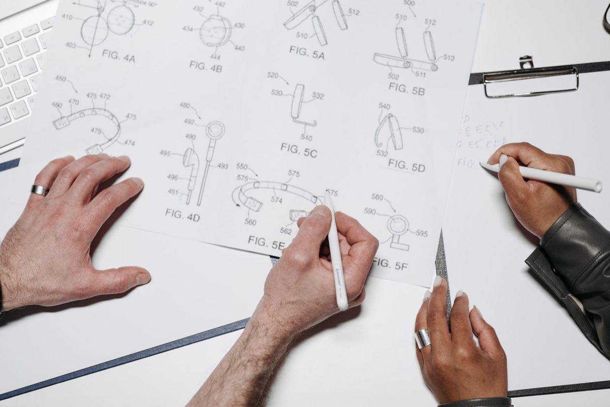 Engineers collaborating over technical drawings