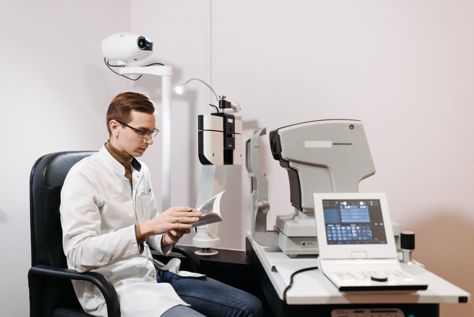 A clinical investigator examining a patient with diagnostic equipment