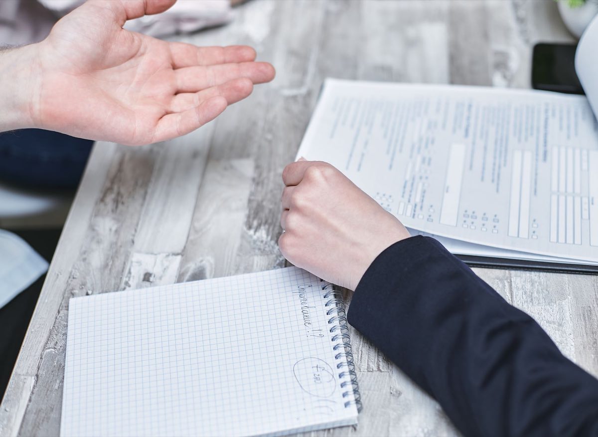 A labelling professional reviewing printed proofs at a desk