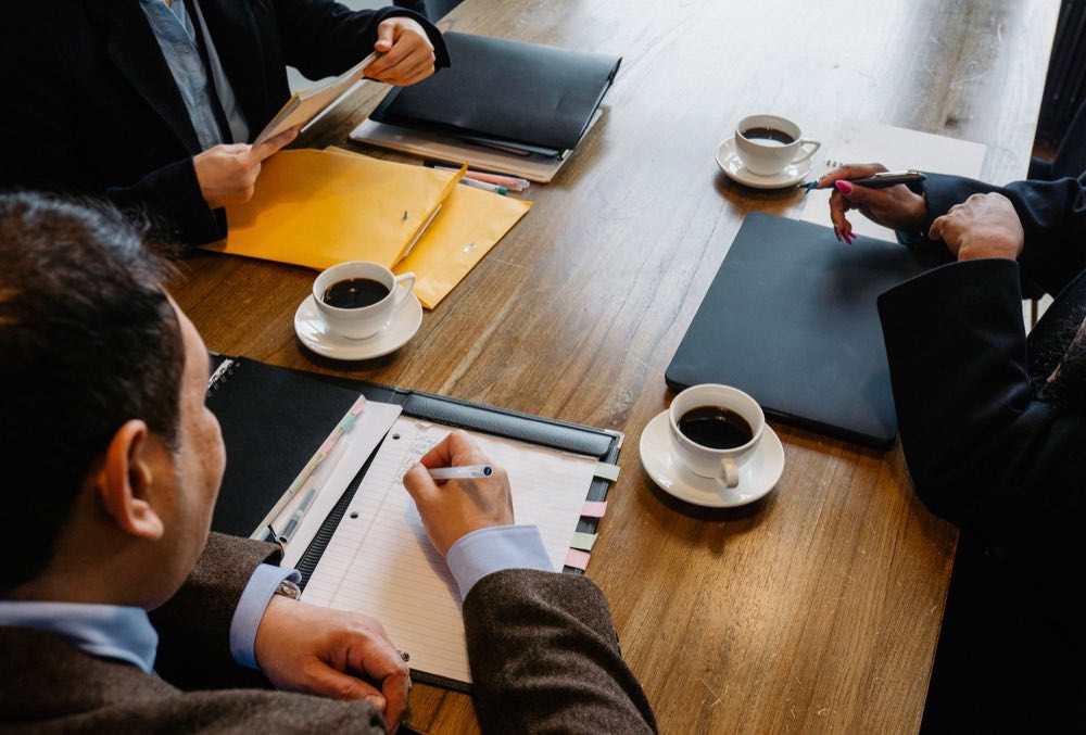 Colleagues reviewing documentation and diagrams together at a table