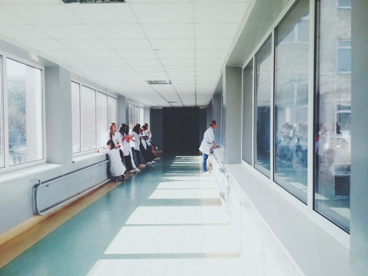 Hospital corridor where a payer coverage decision determines whether patients reach a therapy