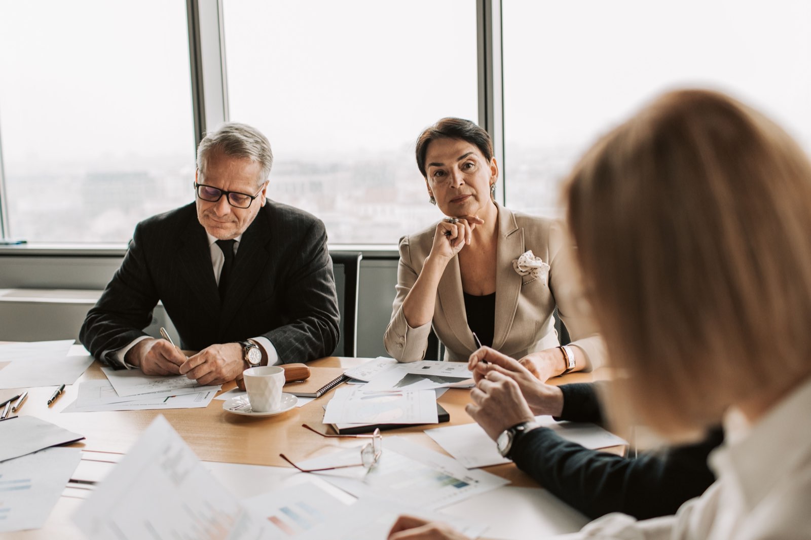 A payer committee reviewing evidence across a boardroom table