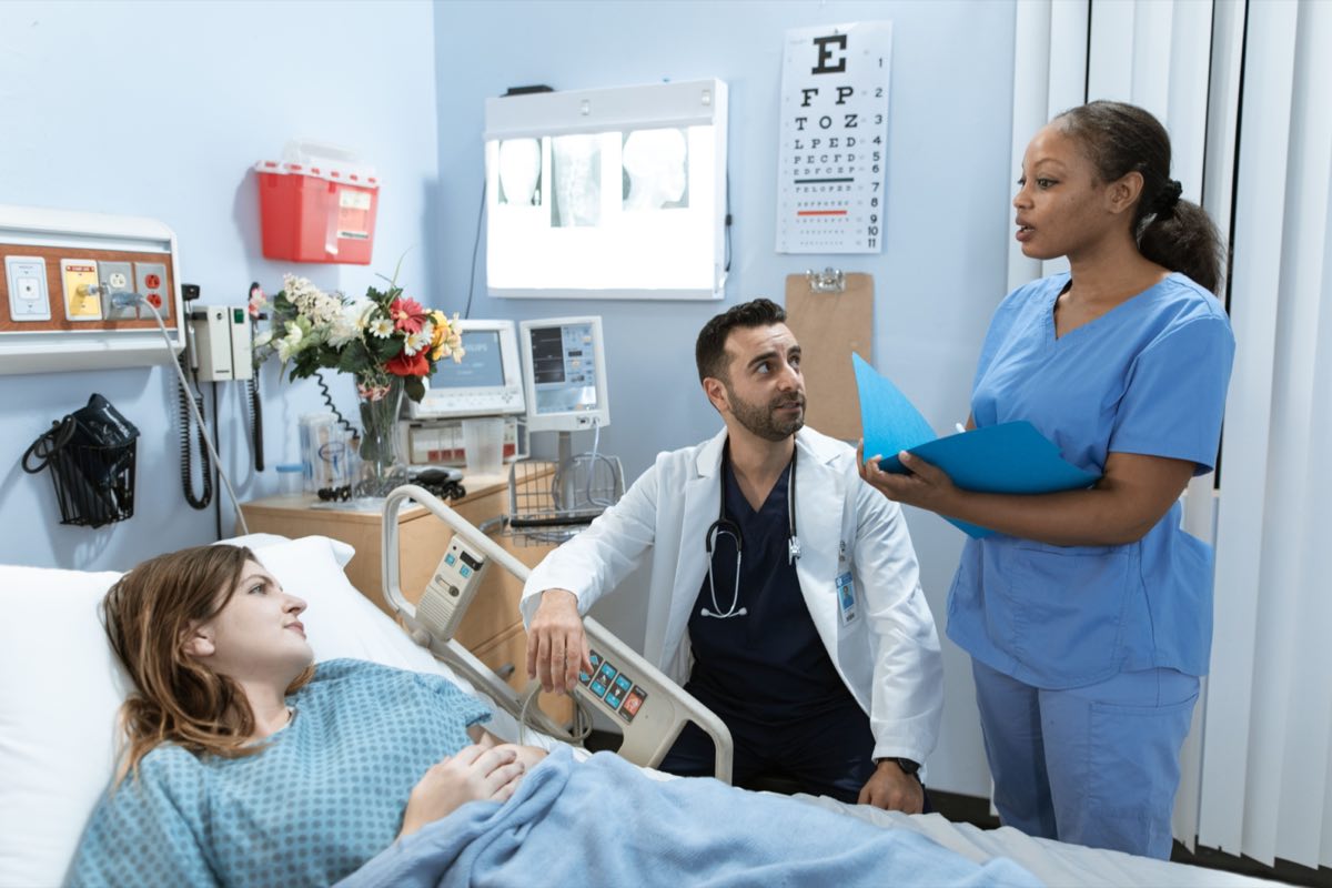Canadian healthcare professionals conferring in a hospital corridor