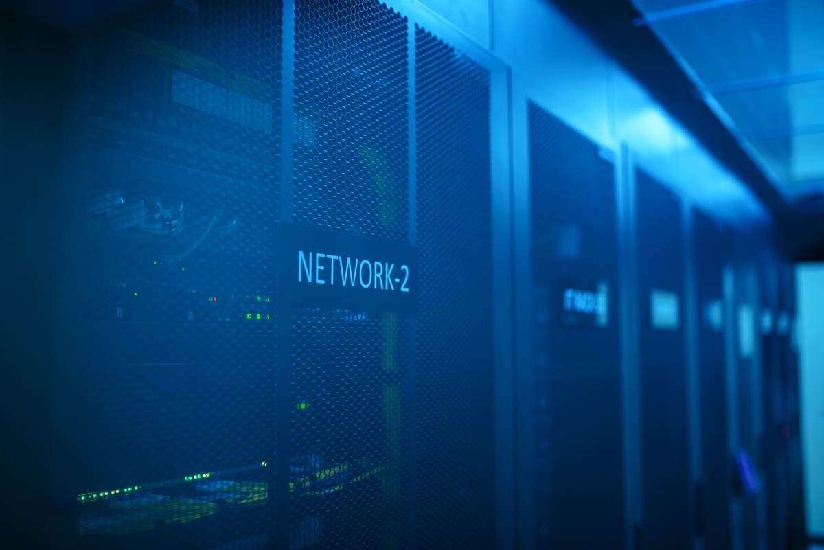 A modern server room with blue-illuminated network equipment
