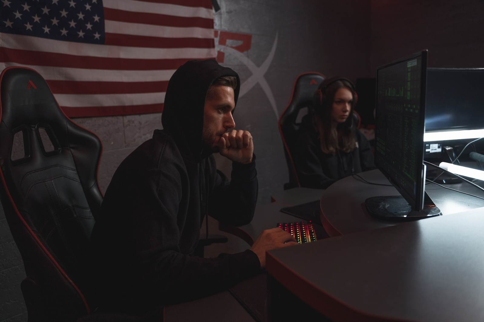 Two analysts reviewing data in a dimly lit security operations setting