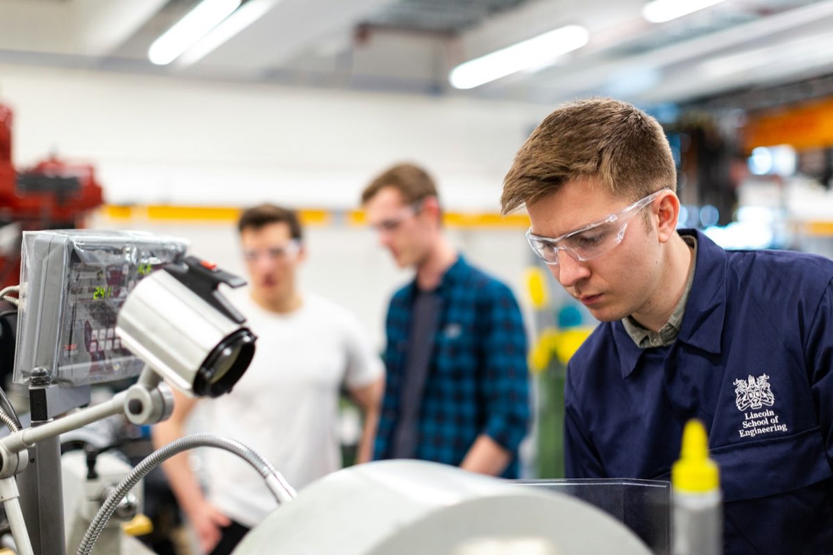Engineers evaluating a device on a test bench