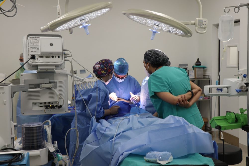 Team of surgeons operating in a well-equipped surgical room