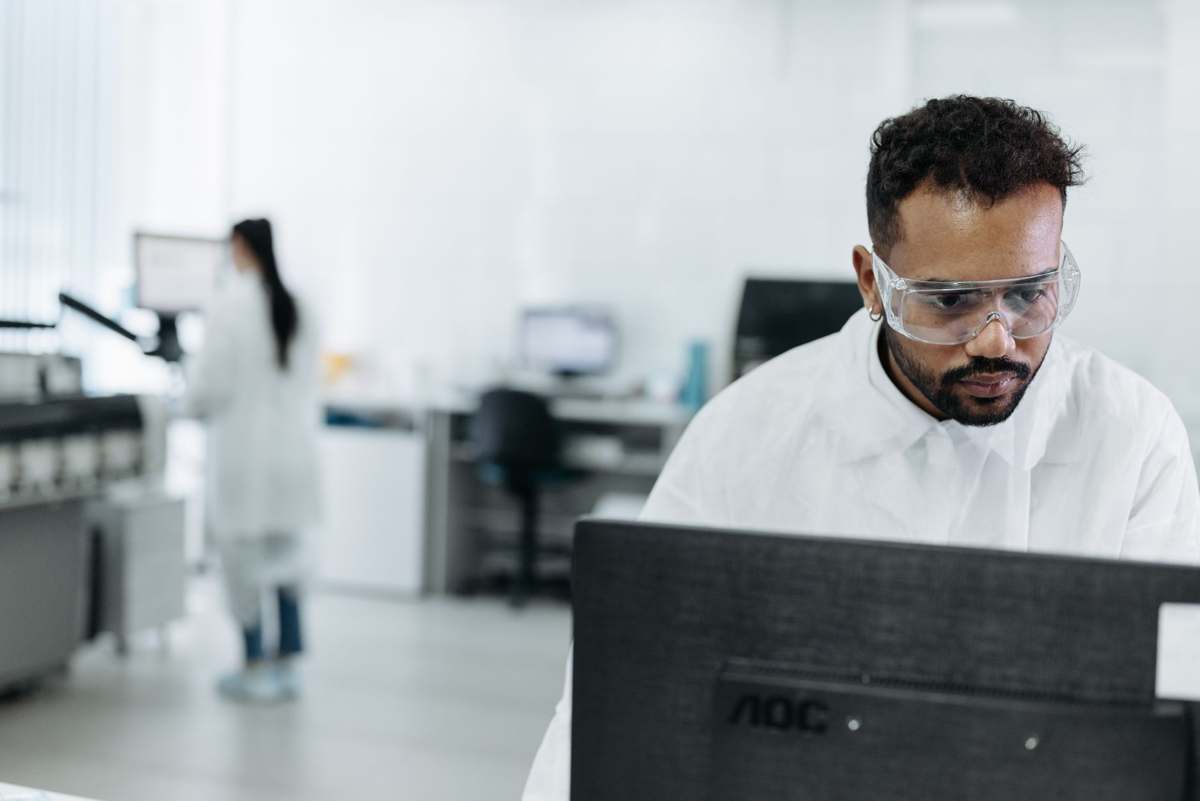 A scientist analyzing genomic data on a computer in a laboratory