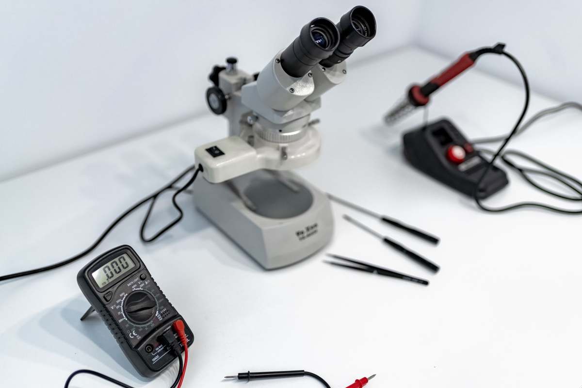 A laboratory workbench with a microscope and precision instruments