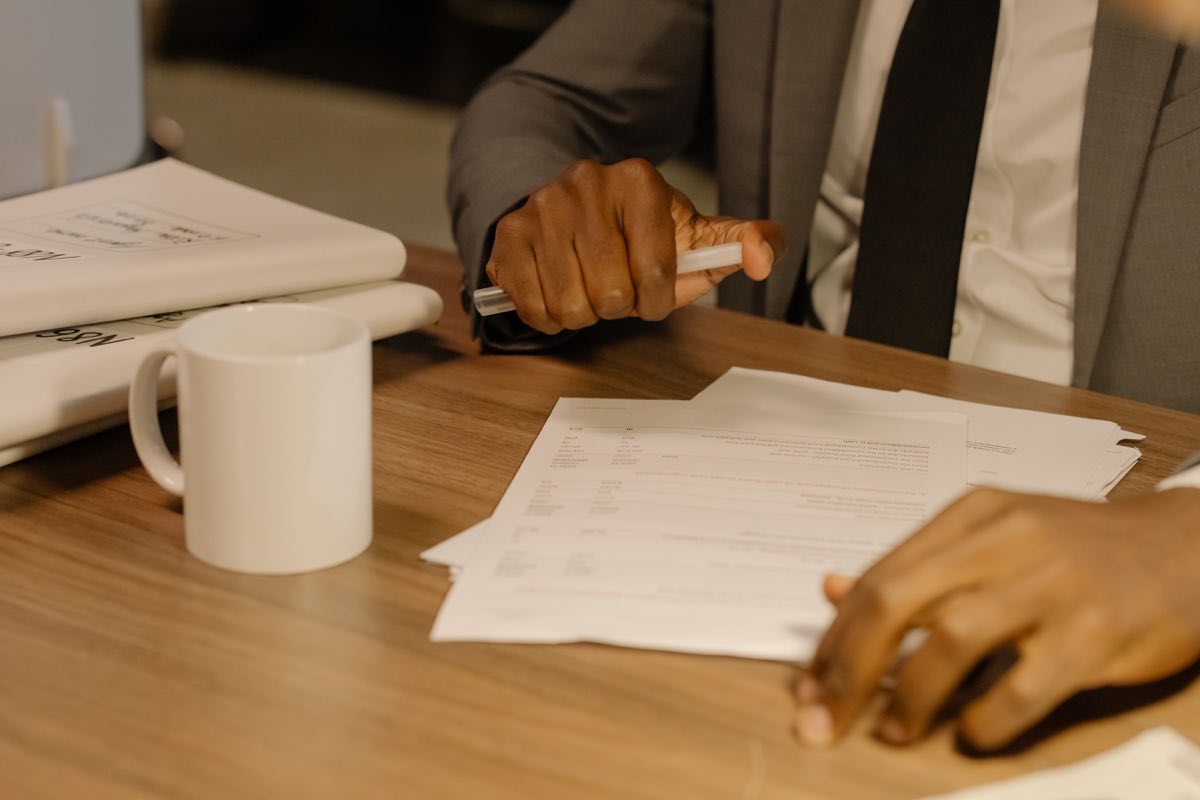 A businessman paging through a bound report