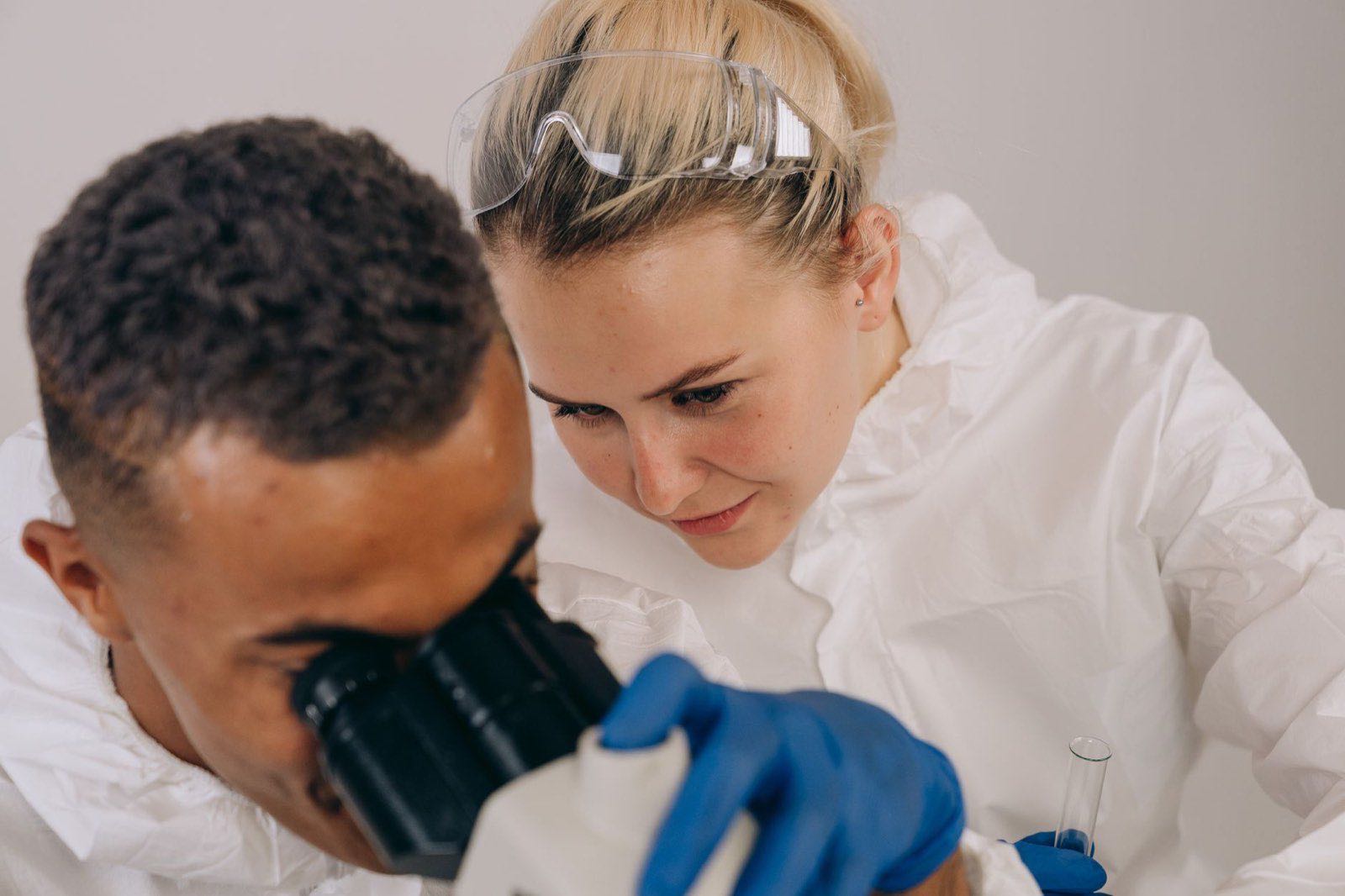 Two scientists conducting microscopic research in a laboratory