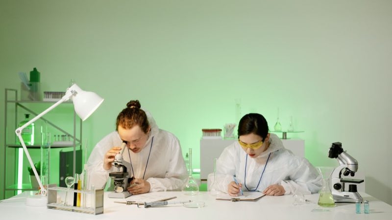 Nonclinical scientists in protective gear running and documenting a GLP study
