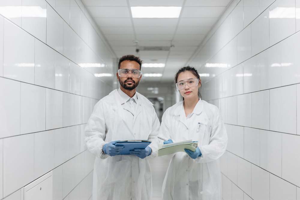 Pharmaceutical professionals walking through a production facility
