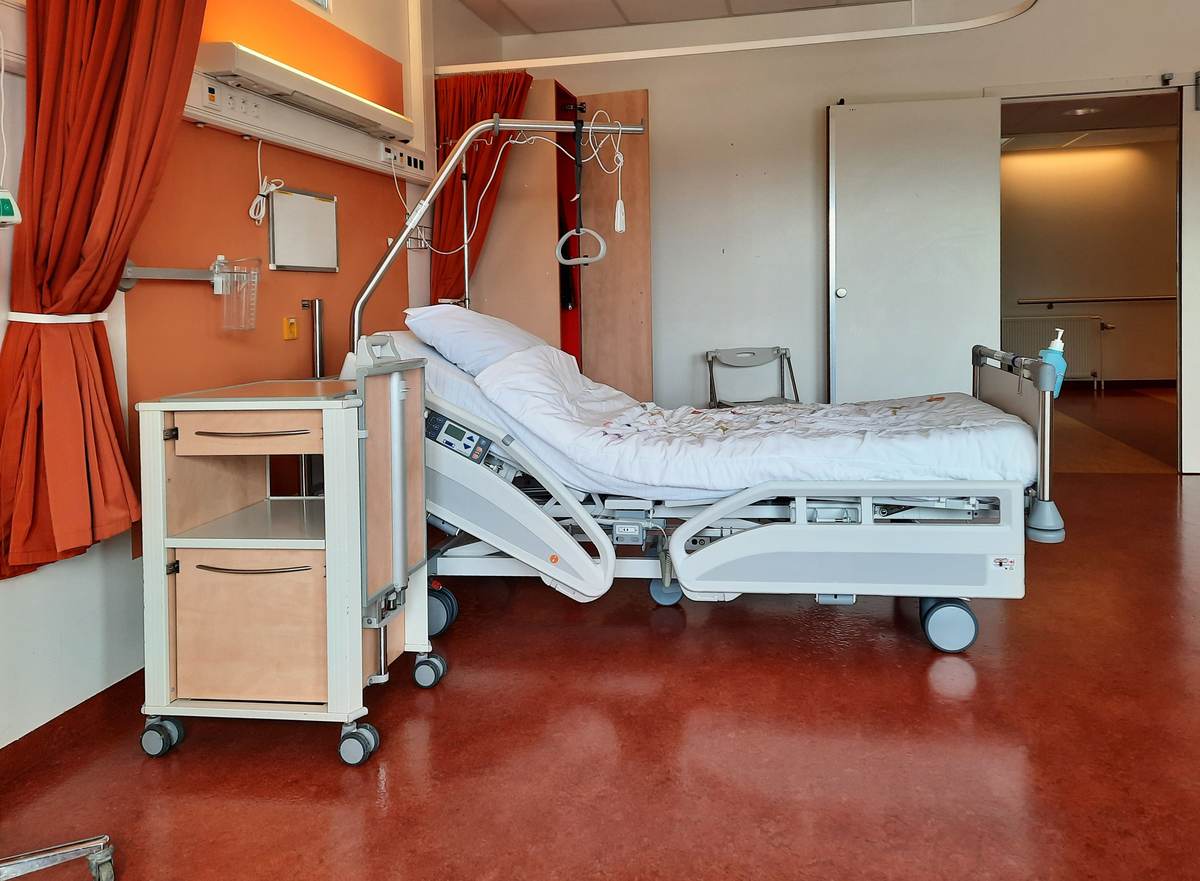 A clean, modern hospital room equipped with monitoring equipment