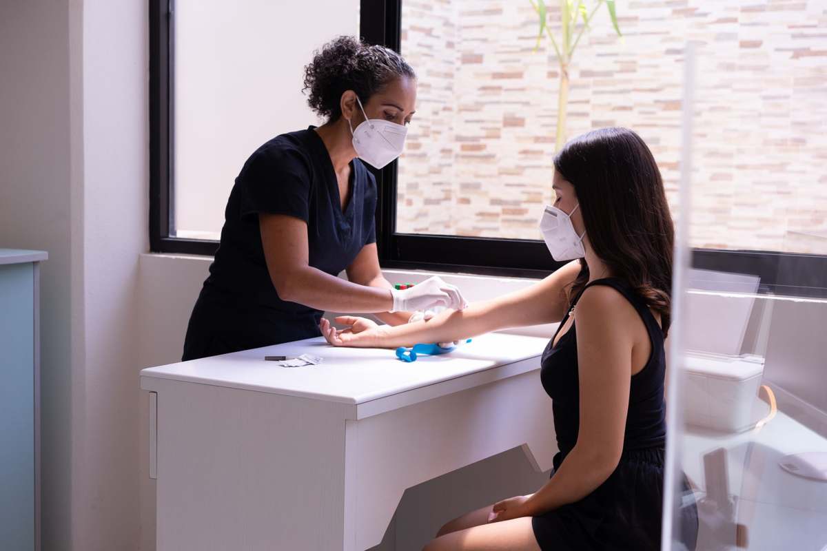 A healthcare professional performing a test with a patient in a clinic