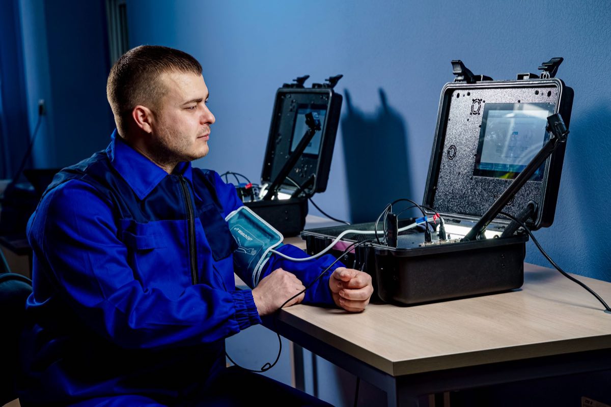 Technician evaluating a medical device in a clinical setting