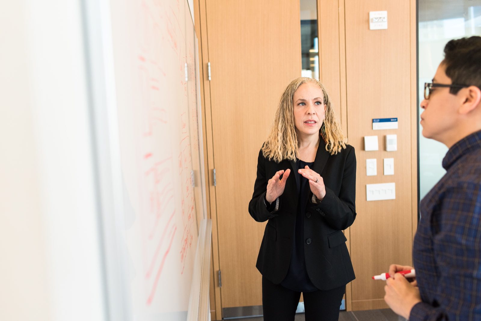 Two professionals in a focused business discussion in a bright meeting room