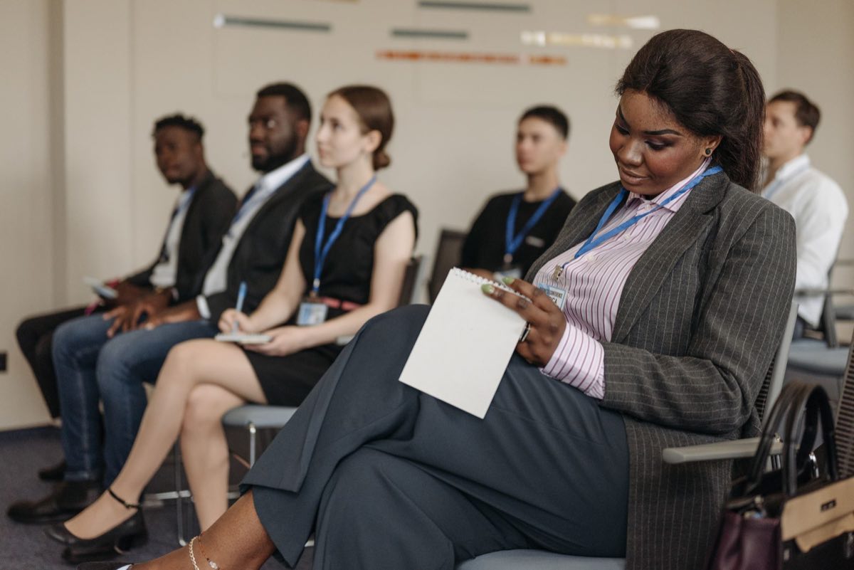 Professionals in a training seminar taking notes