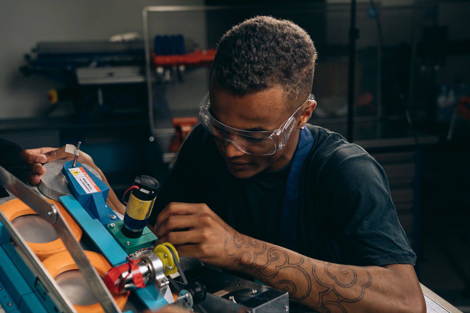 A quality engineer inspecting equipment on a precision manufacturing line