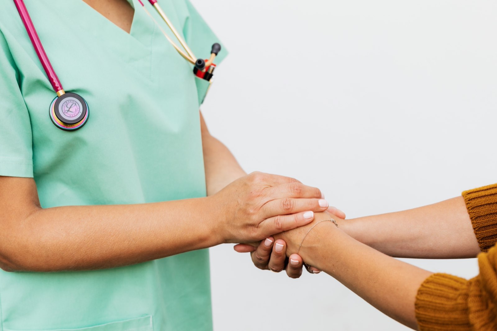 A clinician holding a rare-disease patient's hands