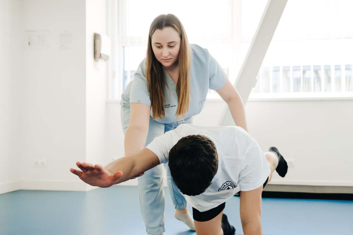 A physiotherapist assisting a patient with rehabilitation exercises