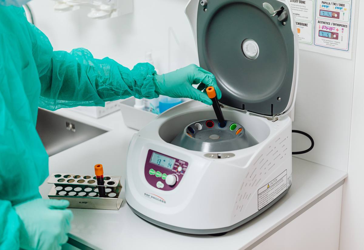 Scientist operating a closed-system cell-therapy manufacturing suite