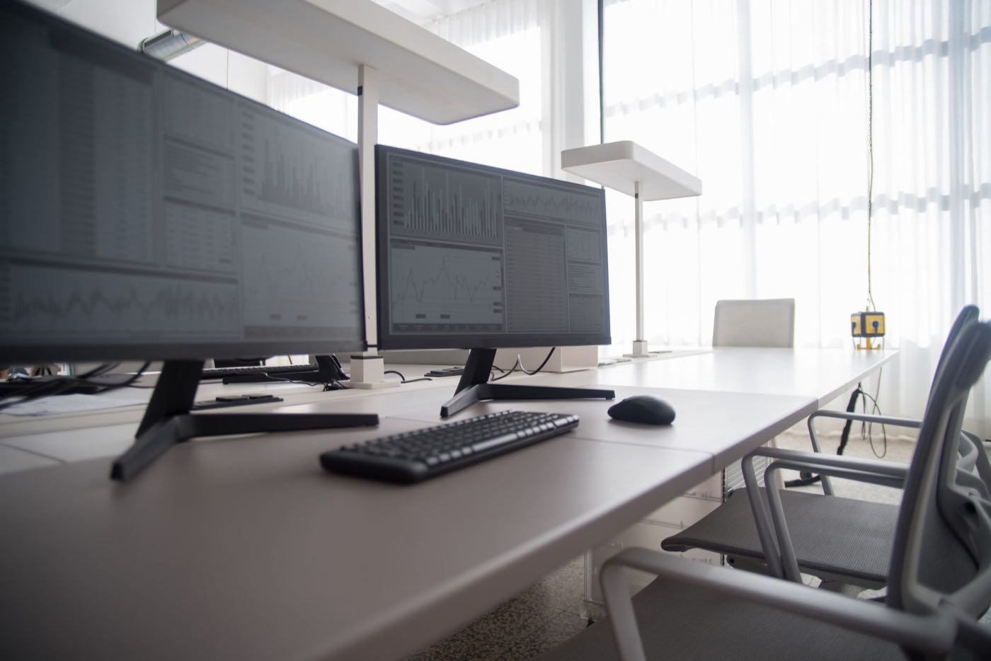 Regulatory monitoring workstation with multiple screens tracking agency sources