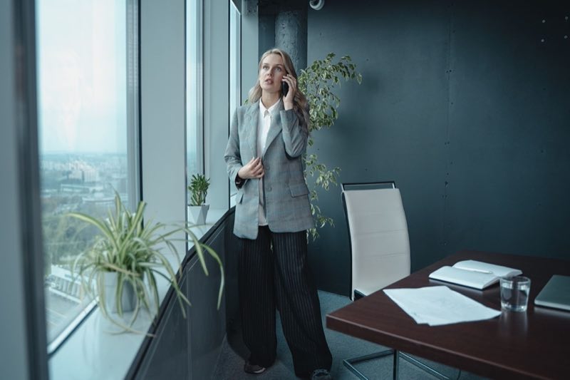 Senior regulatory analyst discussing a new agency signal with a client by phone