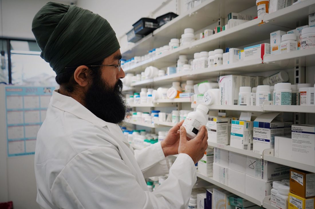 A pharmacist reading a medicine label