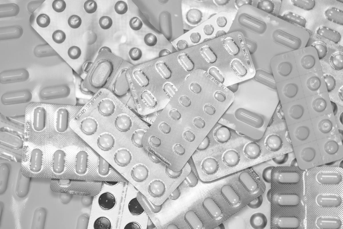 Dozens of pharmaceutical blister packs, one for every market a label must stay consistent across