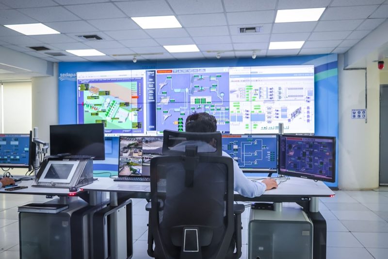 Operations specialist monitoring submission systems from a control room