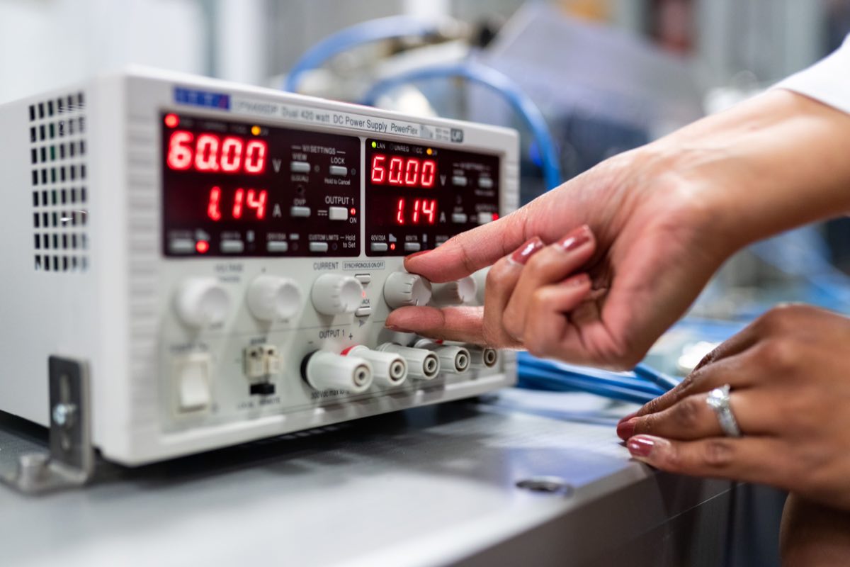 Engineer adjusting calibrated test instrumentation in a laboratory