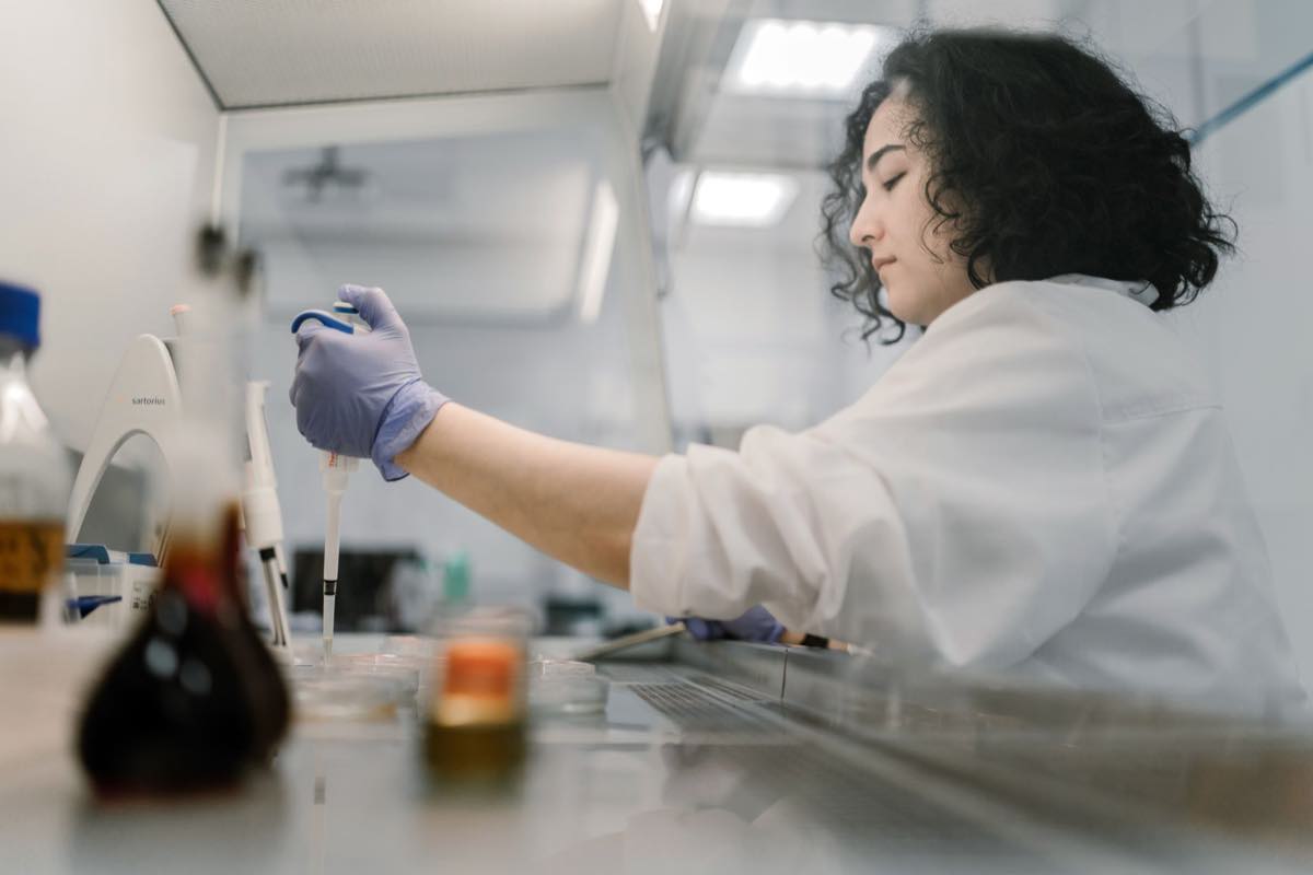 A scientist pipetting samples in a cleanroom