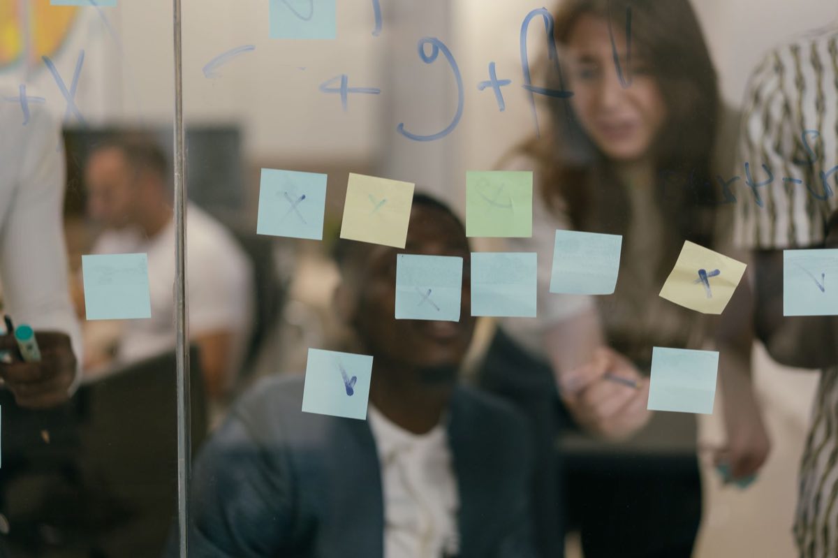 Team working through an assessment on a board of colorful notes
