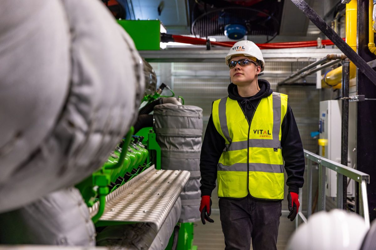 Engineer inspecting factory equipment for quality and safety