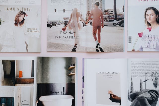 Printed magazine spreads pinned side by side for review