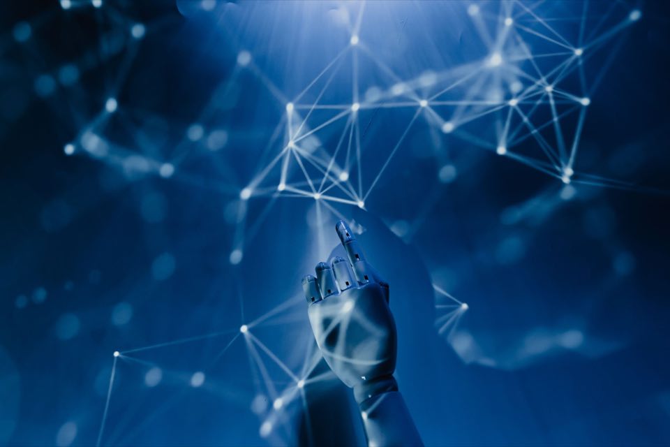 Robotic hand reaching into a lattice of connected light