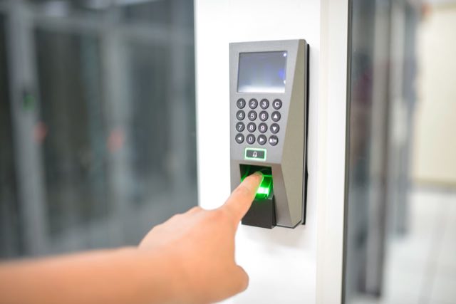 Fingertip pressed to a biometric access scanner