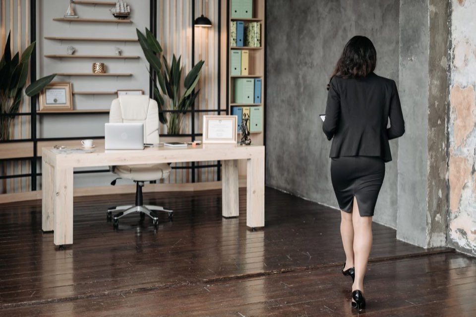 Consultant crossing the atrium of a modern office